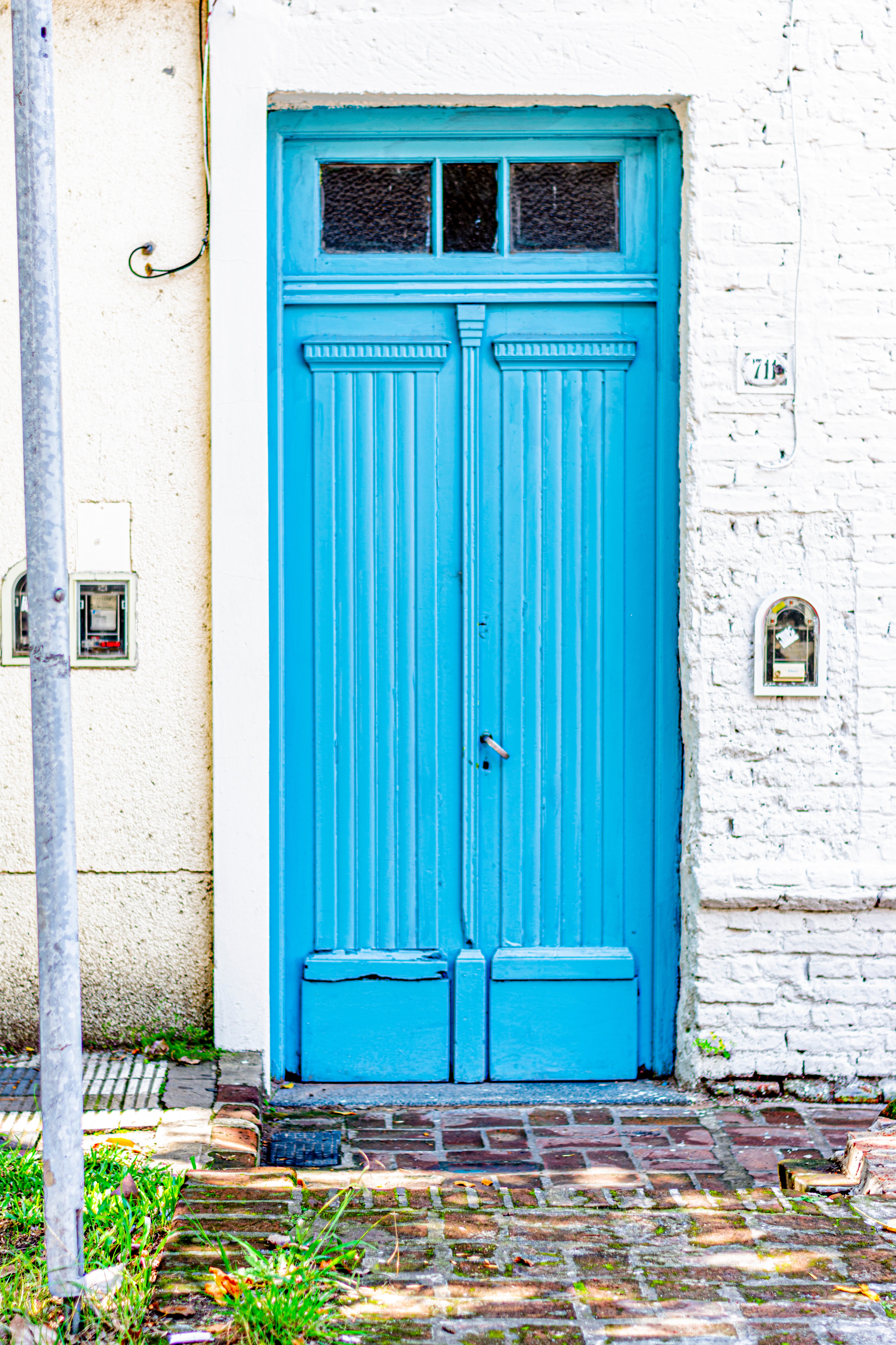 Old high wooden door painted in light blue color