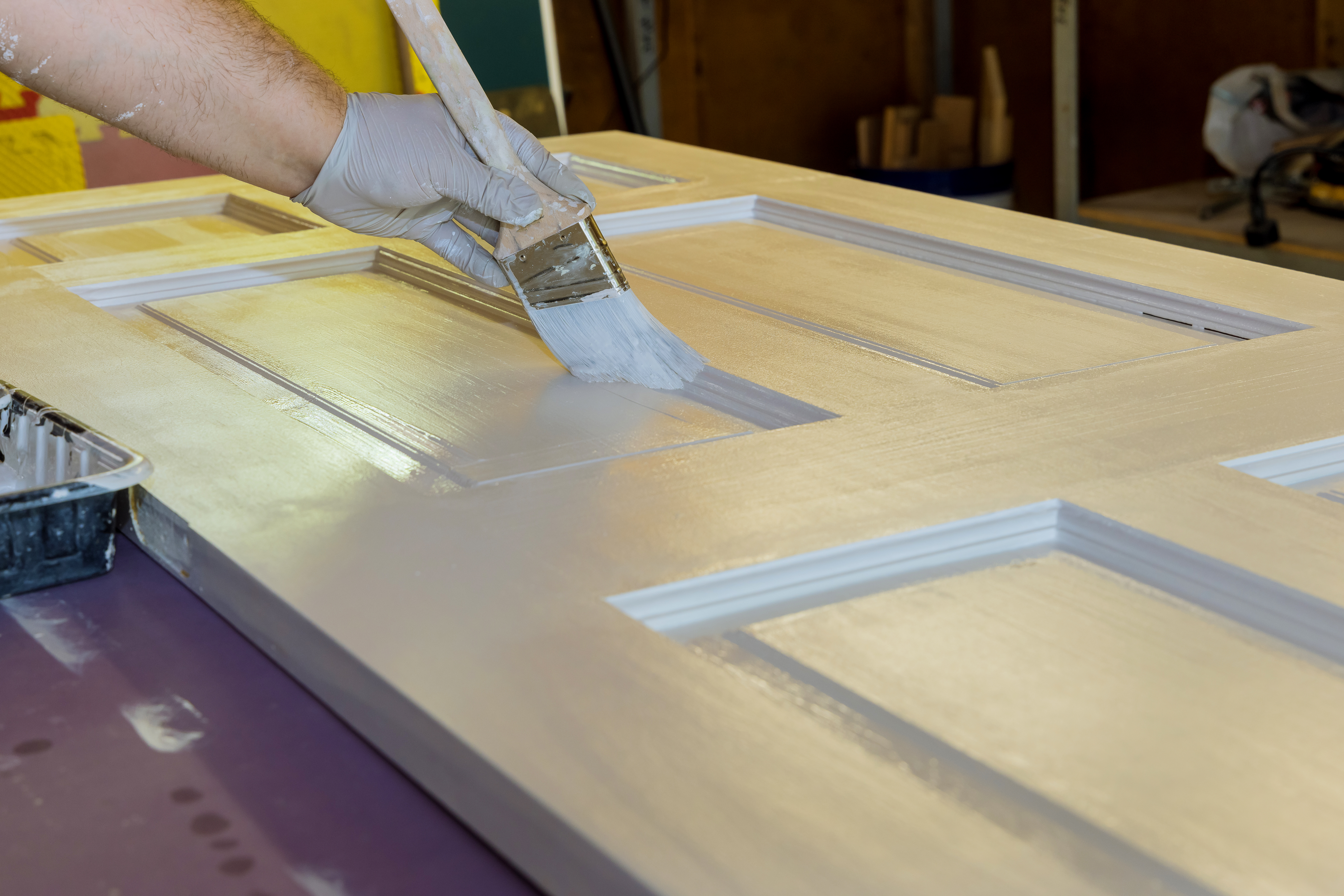 Woodwork master processes for painting wooden doors with using paintbrush